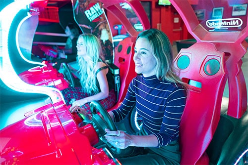 two girls play an arcade game at k1 speed
