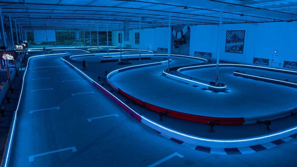 the indoor go kart track inside k1 speed thousand oaks, lined with led lights